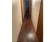 Hallway with hardwood flooring and doors leading to various rooms at 108 E Jasmine St, Mesa, AZ 85201