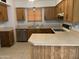 Kitchen with stainless steel dishwasher, oak cabinets, and tile floors at 108 E Jasmine St, Mesa, AZ 85201