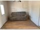 Living room featuring a couch, laminate flooring, and a back door at 108 E Jasmine St, Mesa, AZ 85201