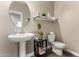 Elegant powder room featuring a pedestal sink and decorative accents at 1297 W Chillingham W Rd, San Tan Valley, AZ 85143