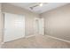 Carpeted bedroom with white double door closet and doorway visible to another room at 1297 W Chillingham W Rd, San Tan Valley, AZ 85143