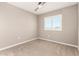Neutral carpeted bedroom with ceiling fan and window with white shutters at 1297 W Chillingham W Rd, San Tan Valley, AZ 85143