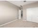 Carpeted bedroom with white double door closet and doorway visible to landing with railing at 1297 W Chillingham W Rd, San Tan Valley, AZ 85143