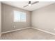 The carpeted bedroom features neutral walls, a ceiling fan, and a window with white shutters at 1297 W Chillingham W Rd, San Tan Valley, AZ 85143