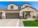 Inviting two-story home boasts a spacious garage and covered front porch at 1297 W Chillingham W Rd, San Tan Valley, AZ 85143