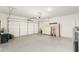 Spacious two-car garage with a functional overhead door and ample space for storage and vehicle parking at 1297 W Chillingham W Rd, San Tan Valley, AZ 85143