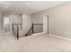 Neutral-toned hallway with plush carpeting, and a staircase with modern metal railing at 1297 W Chillingham W Rd, San Tan Valley, AZ 85143