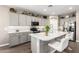 Well-lit kitchen featuring gray cabinets, stainless appliances, quartz countertops and a center island with barstool seating at 1297 W Chillingham W Rd, San Tan Valley, AZ 85143