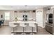 Bright eat-in kitchen with gray cabinets, stainless appliances, a pantry and quartz countertop island with barstool seating at 1297 W Chillingham W Rd, San Tan Valley, AZ 85143