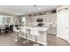 Bright eat-in kitchen with gray cabinets, stainless appliances and quartz countertop island with barstool seating at 1297 W Chillingham W Rd, San Tan Valley, AZ 85143