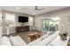 Bright living room with tile floors, white sectional, fireplace entertainment center, and sliding glass doors at 1297 W Chillingham W Rd, San Tan Valley, AZ 85143
