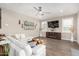 Cozy living room featuring tile floors, a ceiling fan, white sofa, and a modern entertainment center at 1297 W Chillingham W Rd, San Tan Valley, AZ 85143
