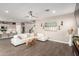Open-concept living room featuring tile floors, a ceiling fan and a comfortable sectional sofa at 1297 W Chillingham W Rd, San Tan Valley, AZ 85143