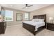 This main bedroom features neutral walls, carpet flooring, a ceiling fan, and windows with white shutters at 1297 W Chillingham W Rd, San Tan Valley, AZ 85143