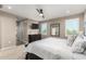 The main bedroom features a ceiling fan, large windows with shutters, and a neutral color palette at 1297 W Chillingham W Rd, San Tan Valley, AZ 85143