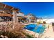 Backyard pool with patio, pergola, and chaise lounges, accented by greenery at 1297 W Chillingham W Rd, San Tan Valley, AZ 85143