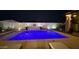 A luxury swimming pool with water feature and elegant hardscape, illuminated in a cozy backyard at 1297 W Chillingham W Rd, San Tan Valley, AZ 85143