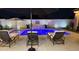 A backyard pool and outdoor seating create a serene oasis, beautifully lit for nighttime enjoyment at 1297 W Chillingham W Rd, San Tan Valley, AZ 85143