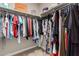 This walk-in closet features an organized hanging system, carpet flooring, and overhead shelving at 1297 W Chillingham W Rd, San Tan Valley, AZ 85143