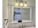 Illuminated bathroom mirror and white vanity with bronze faucet at 13013 N 18Th St, Phoenix, AZ 85022