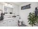 Bathroom featuring updated vanity, stylish mirror, updated toilet and leafy plant accent at 13013 N 18Th St, Phoenix, AZ 85022