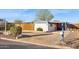 A well-kept home showcasing low-maintenance desert landscaping, a privacy fence, and covered parking at 13013 N 18Th St, Phoenix, AZ 85022