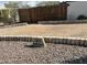 Charming home address marker nestled in rock landscaping with a rustic wooden fence at 13013 N 18Th St, Phoenix, AZ 85022