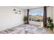 Bright living room with a mountain view, plant accents, a modern rug and light walls at 13013 N 18Th St, Phoenix, AZ 85022