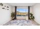 Bright, airy living room with large window, light walls, modern rug and luxury vinyl flooring at 13013 N 18Th St, Phoenix, AZ 85022