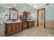 Luxurious bathroom with dual sinks, ornate cabinetry, and walk-in shower at 1330 N 40Th St # 1, Mesa, AZ 85205