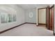 This bedroom features carpet and natural light from the windows with wooden trim at 1330 N 40Th St # 1, Mesa, AZ 85205
