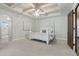 Primary bedroom featuring a tray ceiling, stylish fan, and elegant four-poster bed at 1330 N 40Th St # 1, Mesa, AZ 85205