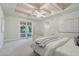 Inviting primary bedroom with a tray ceiling, stylish fan, and patio access at 1330 N 40Th St # 1, Mesa, AZ 85205