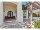 Arched entrance way featuring decorative columns, brick flooring, and a wooden pergola at 1330 N 40Th St # 1, Mesa, AZ 85205