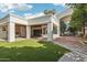 Back exterior showing a covered patio and lush lawn at 1330 N 40Th St # 1, Mesa, AZ 85205
