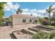 Rear exterior view of home showcasing a spacious backyard with garden beds, landscaping, and a tiled roof at 1330 N 40Th St # 1, Mesa, AZ 85205
