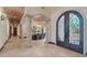 Open foyer featuring stone columns, arched doorways, and views of the dining area at 1330 N 40Th St # 1, Mesa, AZ 85205