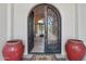 Ornate arched front door with large glass panes and black iron designs opens to the entry way at 1330 N 40Th St # 1, Mesa, AZ 85205