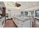 Bright kitchen featuring a large center island with bar seating, custom cabinets, and hardwood floors at 1330 N 40Th St # 1, Mesa, AZ 85205