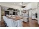 Open kitchen with island seating, a brick oven hood, and seamless flow to the living area at 1330 N 40Th St # 1, Mesa, AZ 85205