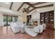 Cozy living room features a stone fireplace, wood beams, and built-in shelving at 1330 N 40Th St # 1, Mesa, AZ 85205