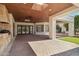 Expansive covered patio with brick flooring, tongue and groove ceiling, outdoor kitchen, and access to the backyard at 1330 N 40Th St # 1, Mesa, AZ 85205