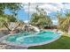 Resort-style pool with a rock waterfall and water slide surrounded by lush landscaping and artificial turf at 1330 N 40Th St # 1, Mesa, AZ 85205