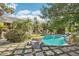 Beautiful pool with rock accents and lush landscaping, offering a serene backyard retreat surrounded by palm trees at 1330 N 40Th St # 1, Mesa, AZ 85205