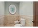 Intimate powder room featuring a round window and classic fixtures at 1330 N 40Th St # 1, Mesa, AZ 85205