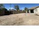 Large backyard area featuring a covered patio and a block wall for privacy at 1354 S 228Th Dr, Buckeye, AZ 85326