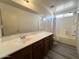 Bathroom featuring a large mirror, a light countertop, and a shower-tub combination at 1354 S 228Th Dr, Buckeye, AZ 85326