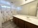 Bathroom featuring a large mirror, light countertop, and shower-tub combination with curtains at 1354 S 228Th Dr, Buckeye, AZ 85326