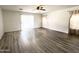 Bright living room featuring wood-look floors and natural light from large windows at 1354 S 228Th Dr, Buckeye, AZ 85326