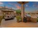 Outdoor kitchen and patio with bbq and lounge chairs in landscaped backyard with a pool at 14708 E Canyoncrest Ct, Fountain Hills, AZ 85268